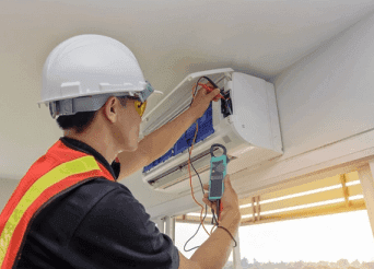 Technician inspecting a residential air-conditioning unit