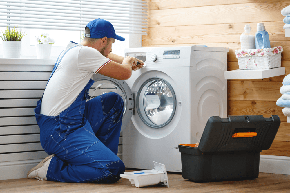 Technician inspecting a household washing machine